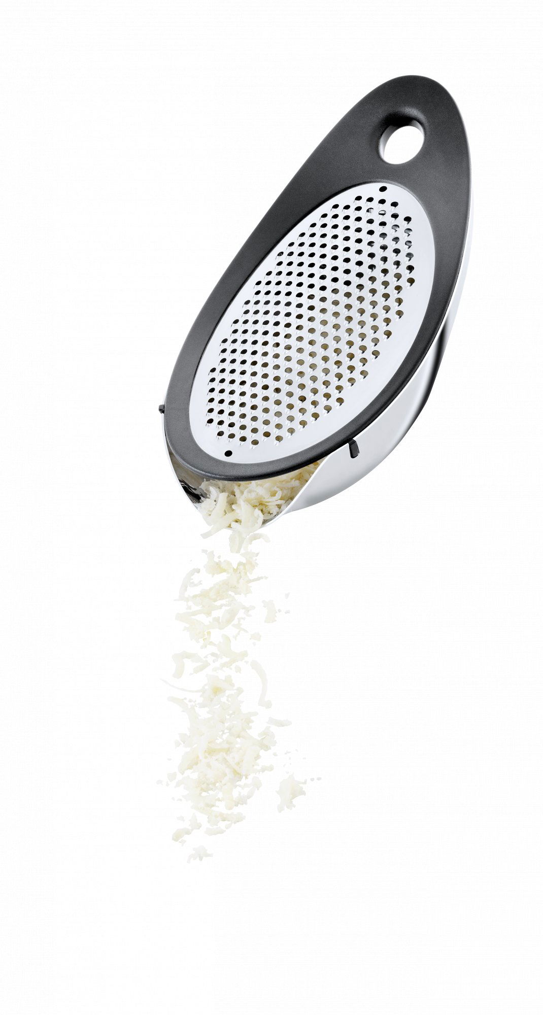 Stainless steel grater with shredded cheese falling out against a black background.