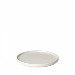White ceramic plate with a smooth surface and minimalist design on a black background.