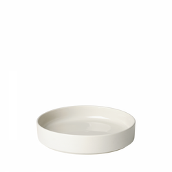 Ceramic white shallow bowl on a black background, perfect for serving dishes or decor.