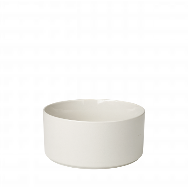 Minimalist white ceramic bowl with a smooth, curved design on a black background.