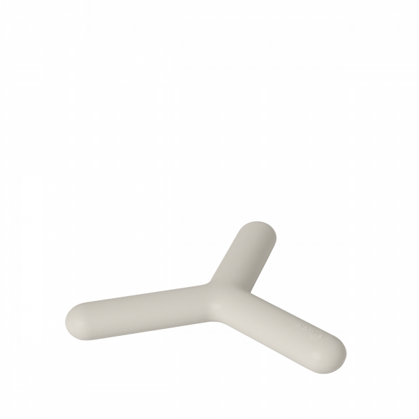 Minimalist beige desk accessory shaped like a Y on a black background.