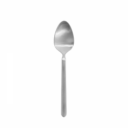 A shiny stainless steel spoon on a black background.