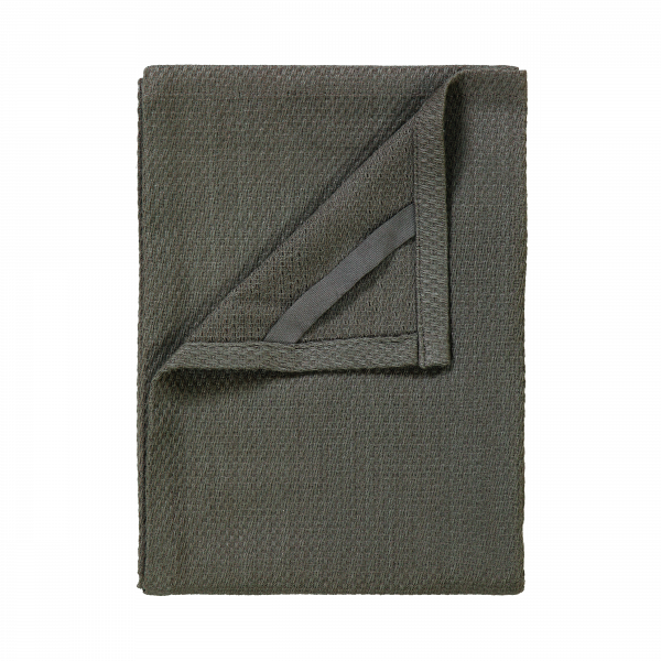 Soft green woven blanket folded on a white background, perfect for cozying up.