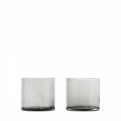 Two clear glass drinking glasses on a black background.