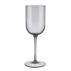 Elegant clear wine glass with a tall stem and wide bowl on a black background.