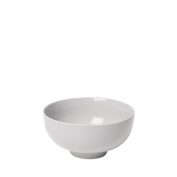 White ceramic bowl with a smooth finish against a black background.
