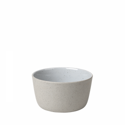 Simple modern ceramic bowl in neutral tones on a black background.
