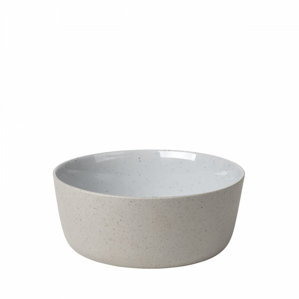 Minimalist white ceramic bowl with a speckled finish on a black background.