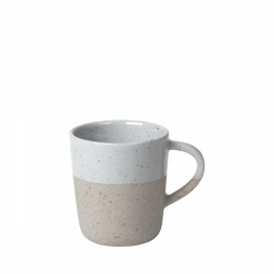 Ceramic mug with a unique speckled design and two-tone color pattern.