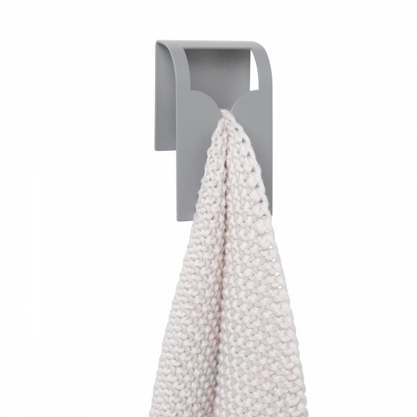 Minimalist gray towel holder with a textured white towel hanging from it.
