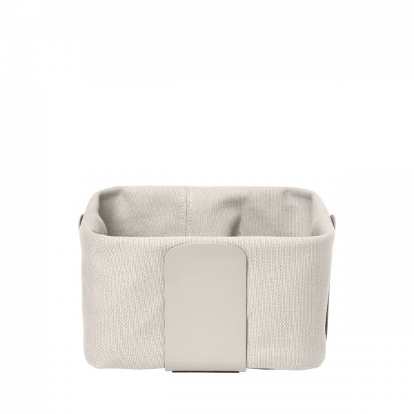 Small fabric storage basket with a minimalist design and a beige color.