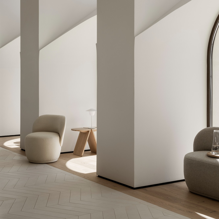 Modern interior design featuring minimalist furniture and natural light in a spacious room.