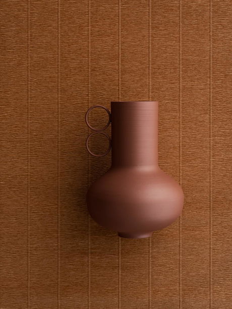 Elegant brown ceramic vase against a textured neutral background.